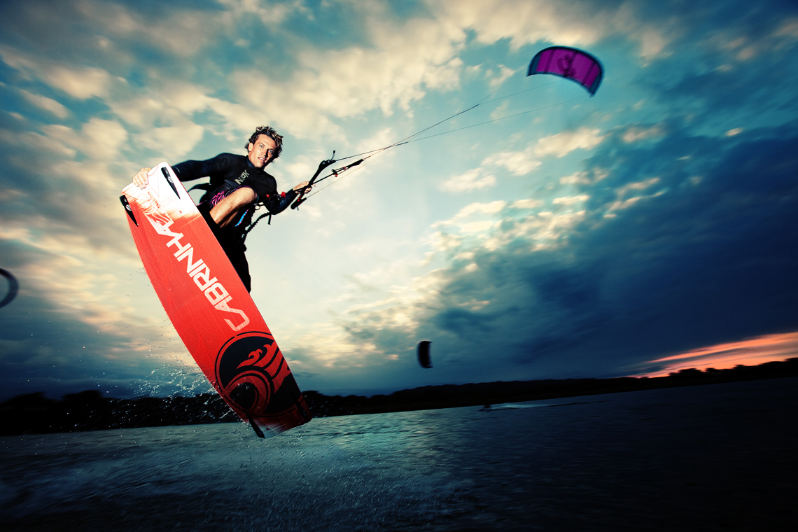Damien LeRoy with a tailgrab at dusk on his Cabrinha kites gear