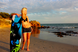 Making the Cabrinha Xcaliber board look good - girl posing with kiteboard