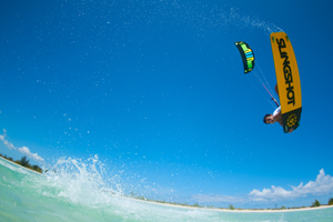 Kiteboarder Victor Hays with a jump and tail grab on the 2016 Slingshot Rally kite and Misfit kiteboard.